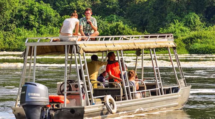 Adventurer white-water rafting on the Nile River in Uganda, surrounded by lush green landscapes and dramatic rapids.