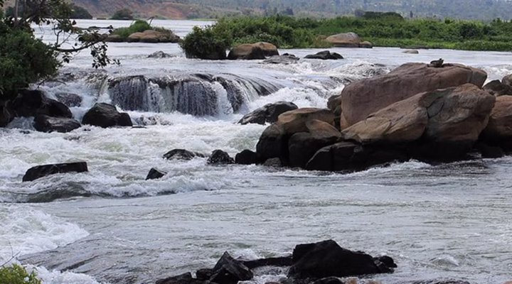Scenic view of a waterfall in Jinja Uganda cascading through rocks surrounded by lush greenery