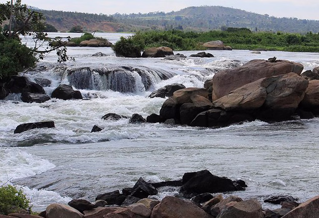 Scenic view of a waterfall in Jinja Uganda cascading through rocks surrounded by lush greenery